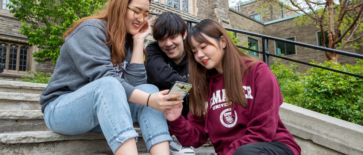 Students looking at a phone